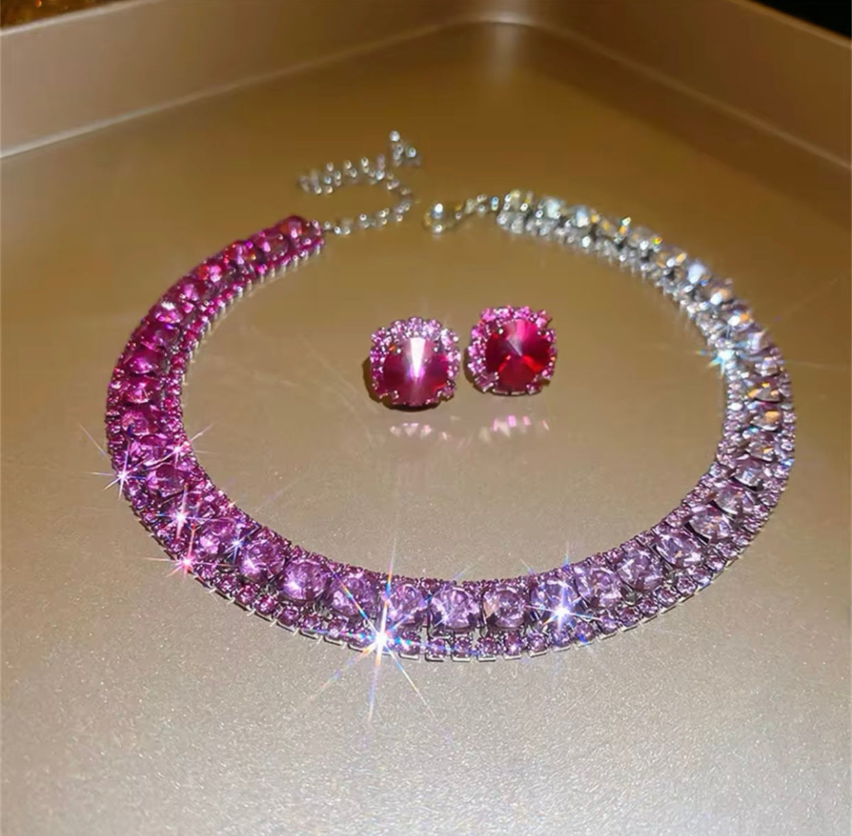 A luxurious crystal necklace set in rich purple tones.