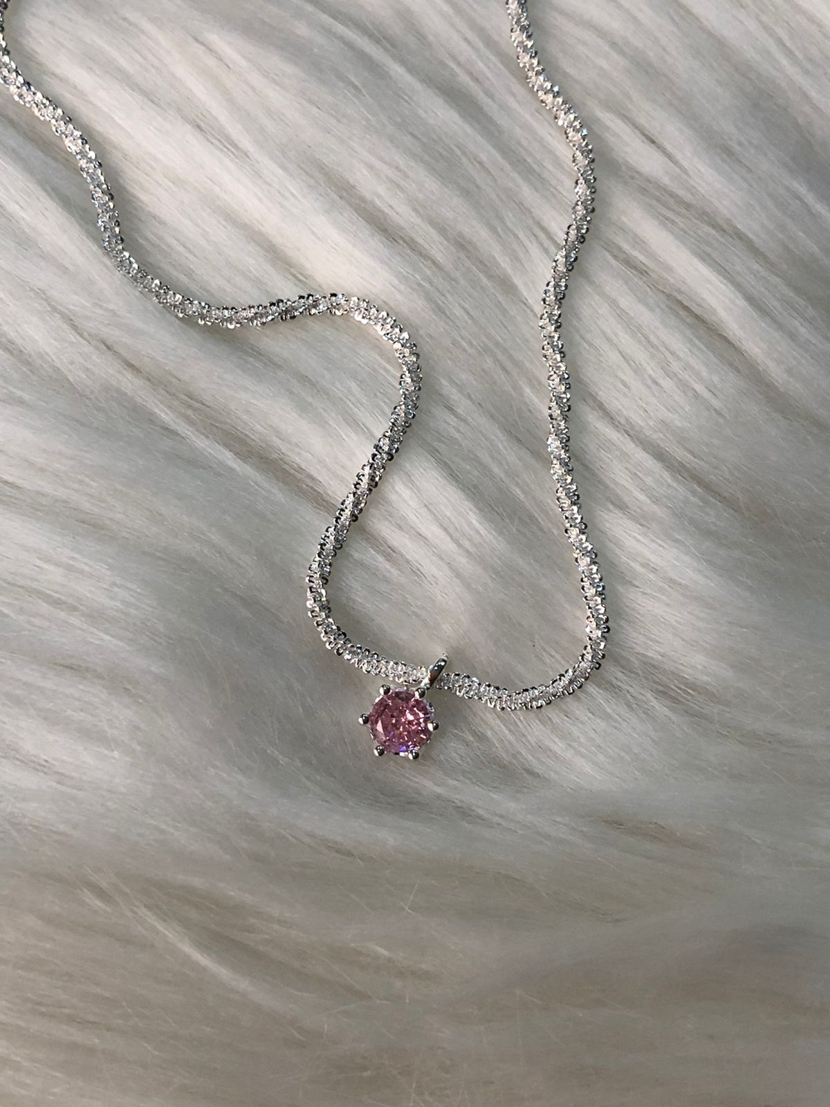 A sparkling rose pink crystal pendant necklace with a sterling silver chain