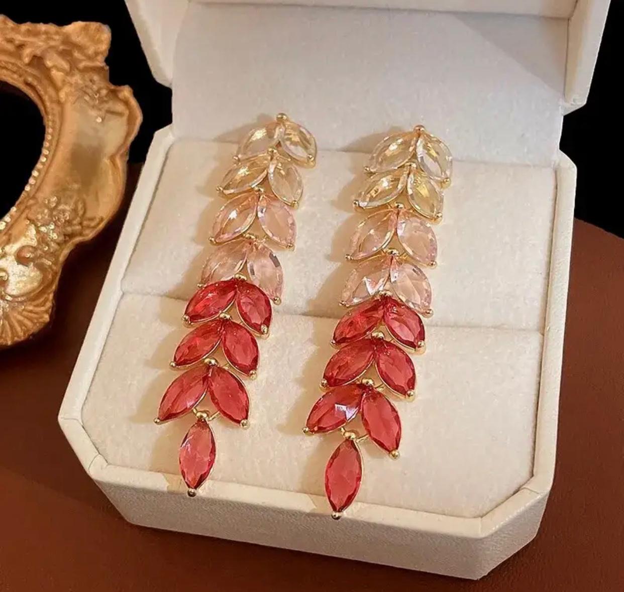 Stylish long red leaf designed dangle earrings for women.