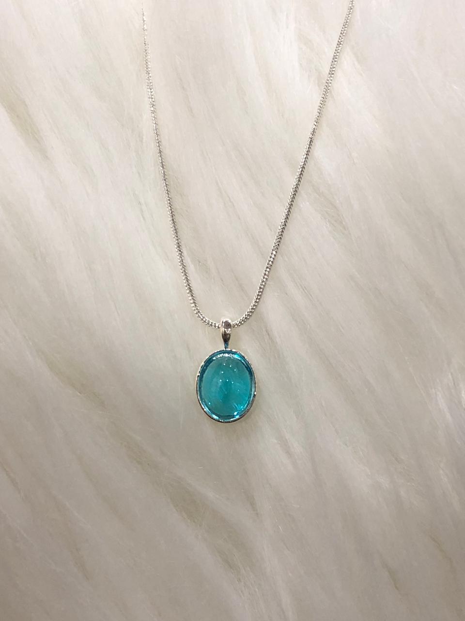 Beautiful ocean blue oval pendant necklace designed in silver