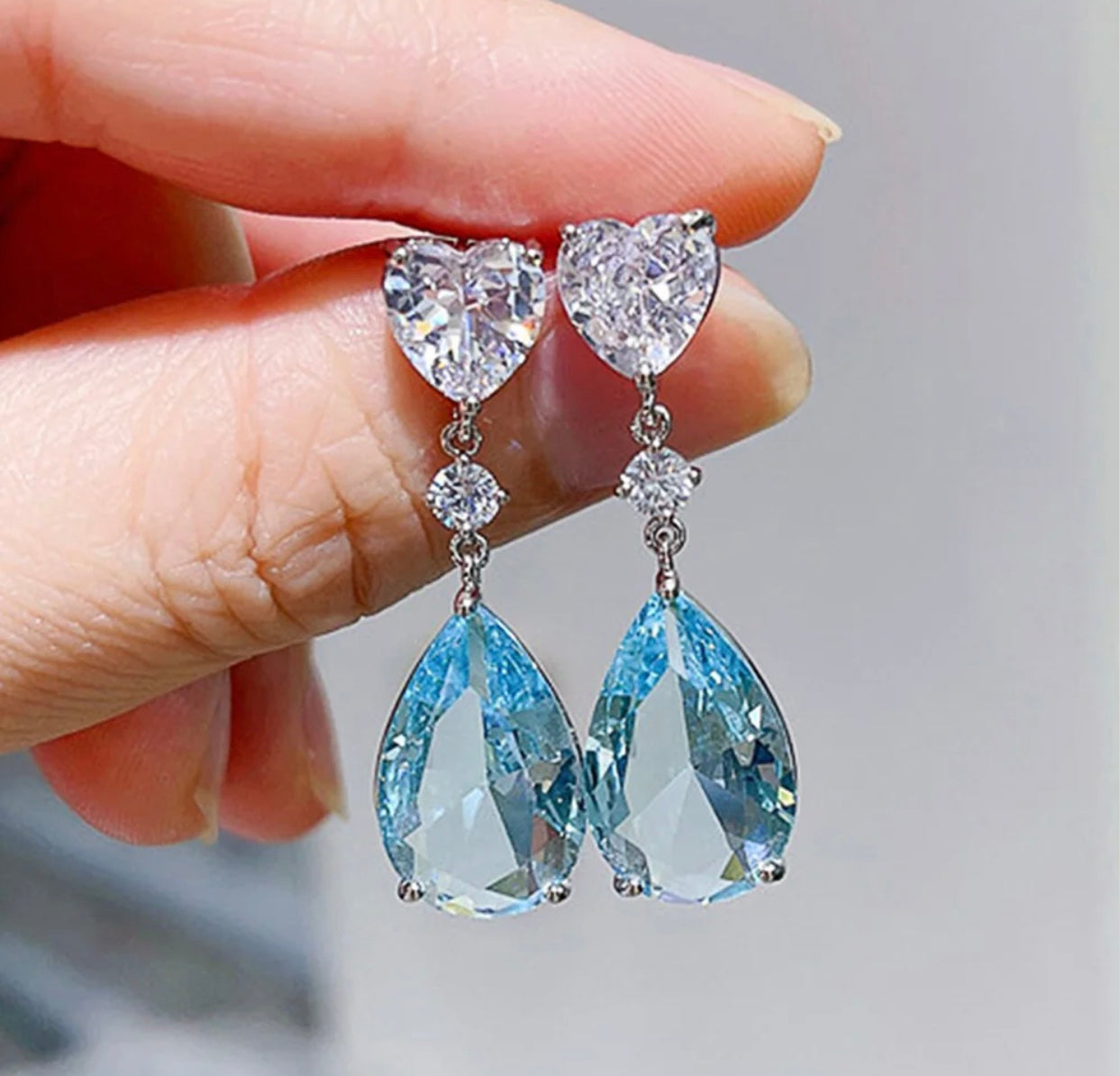 Elegant silver earrings with a sky blue cubic zirconia stone