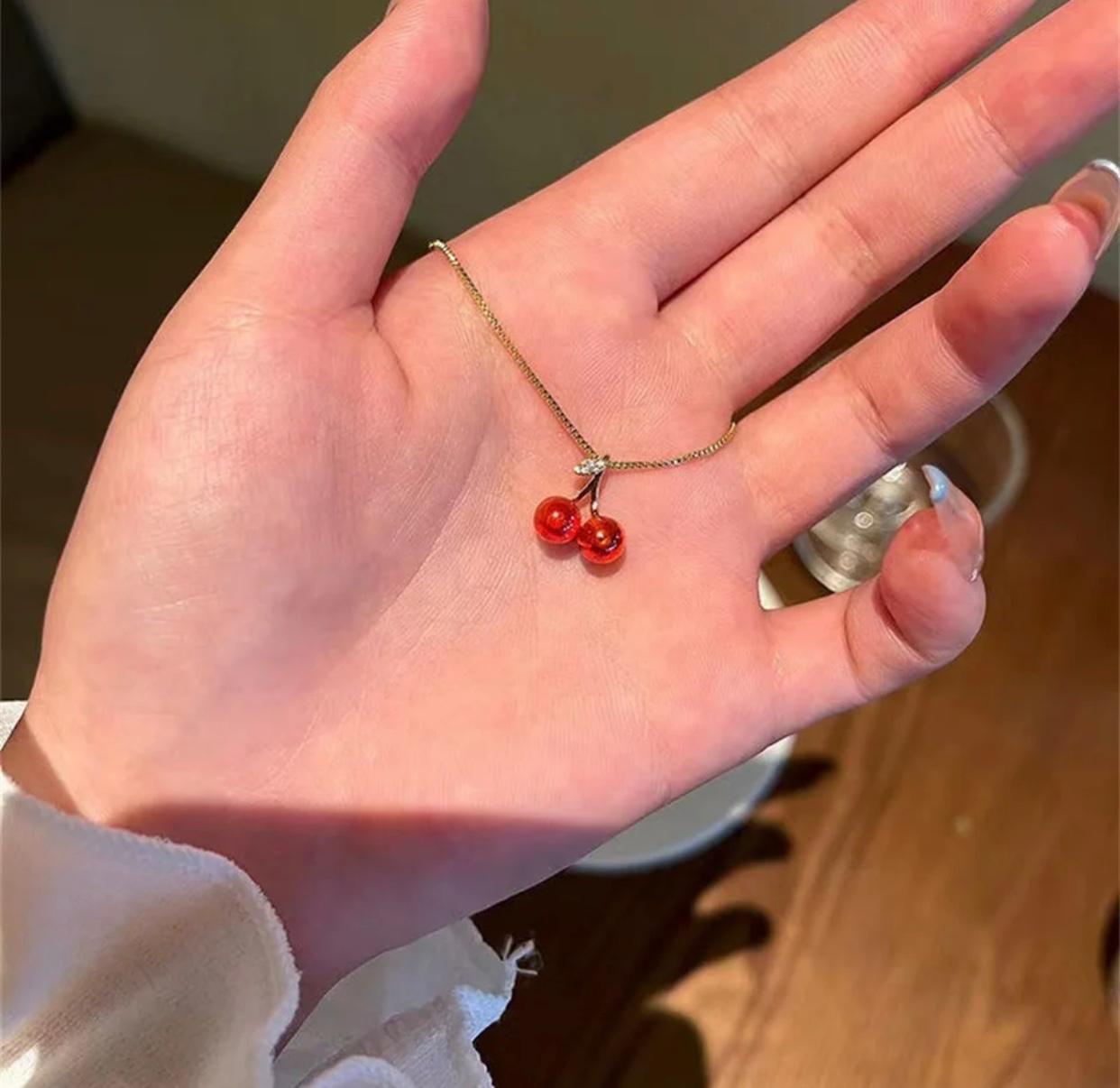 A unique cherry shaped pendant in wine red